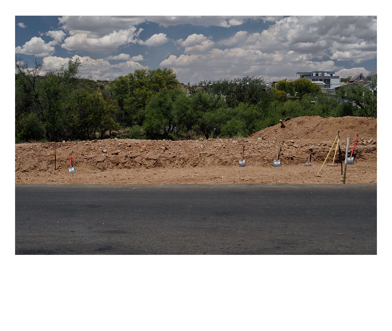 Windhoek-Lunch-Time_Spades-on-the-roadside,-the-workers-somewhere-in-the-shade-of-the-trees